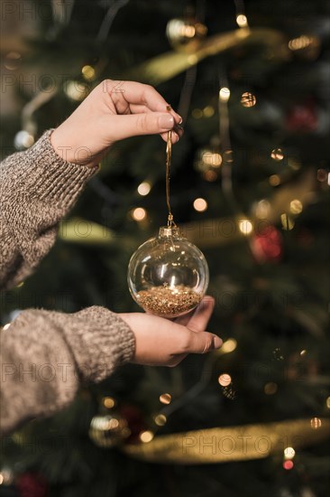 Woman holding ornament transparent christmas ball