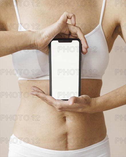Woman holding smartphone close up