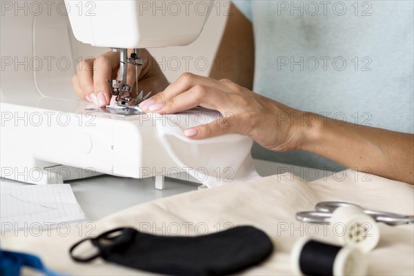 Woman using sewing machine face mask