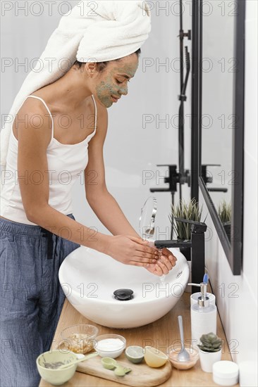 Woman washing off natural ingredients from her hands