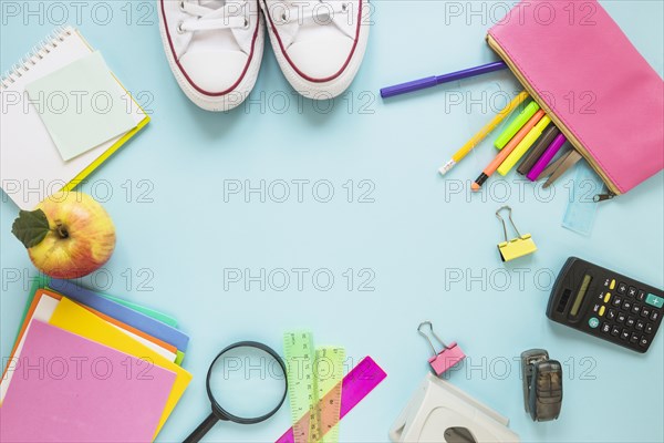 Writing implements sneakers laid circle