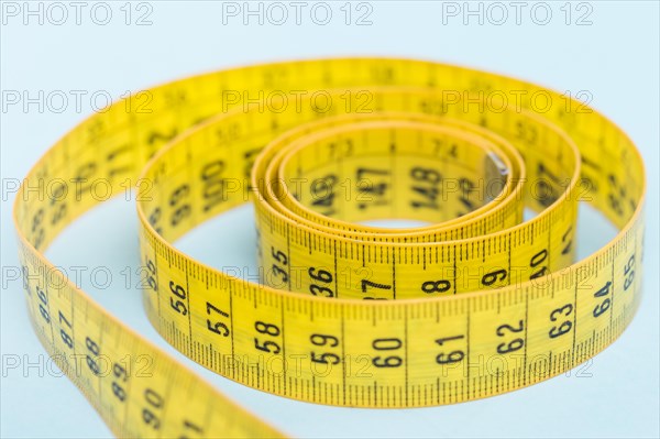 Yellow tape measure blue background