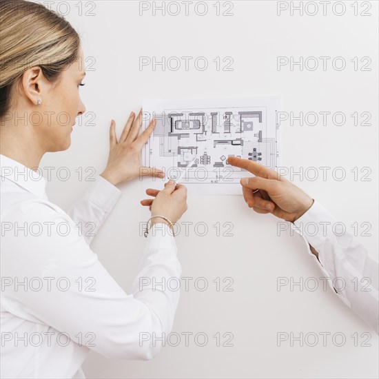 Young female architect designer working blueprint project new apartments