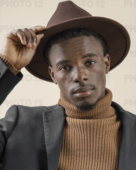 Young handsome man posing with hat 3