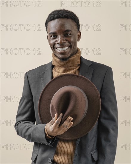 Young handsome man posing with hat 4