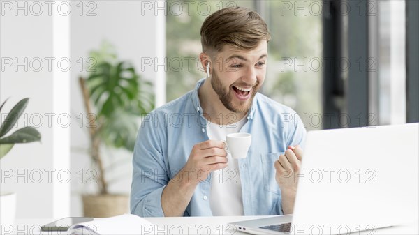 Young man with airpods working laptop