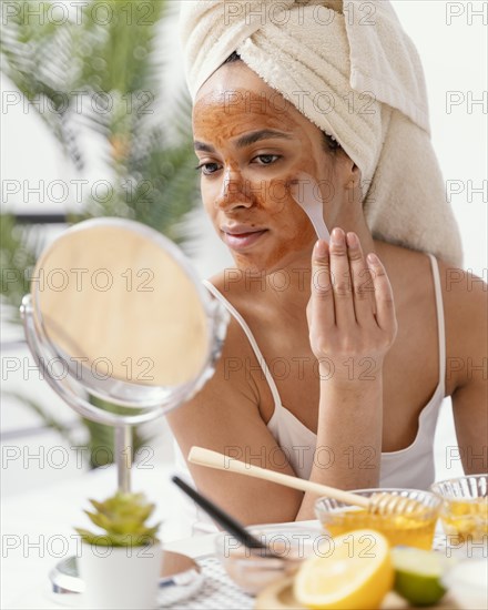 Young woman applying natural face mask 2