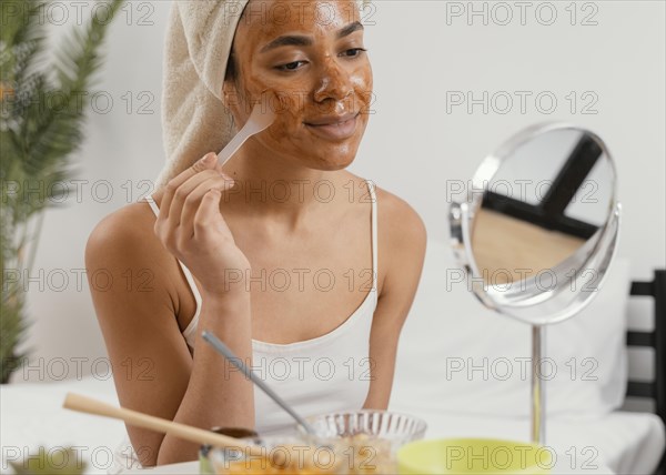 Young woman applying natural face mask 4