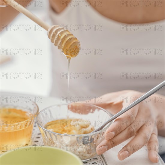 Young woman making natural face mask home 3