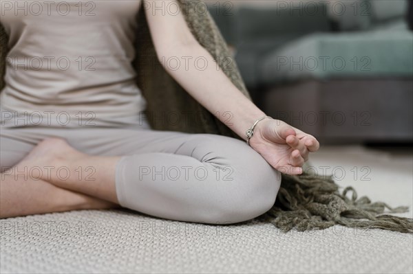 Young woman meditating home close up