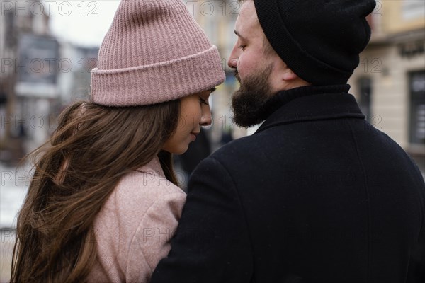 Back view couple outdoor hugging