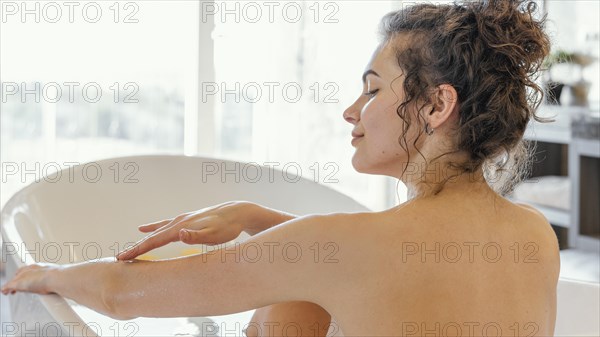 Back view woman bathtub