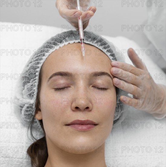 Beautician doing injection filler female client 9