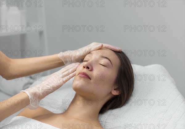 Beautician with female client salon face care routine 7