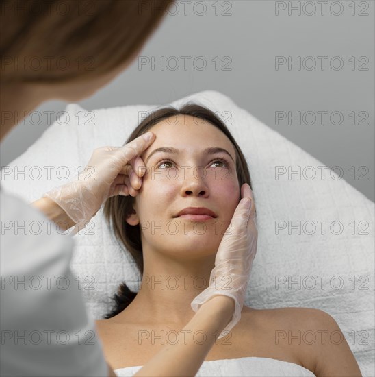 Beautician with female client salon face care routine 9