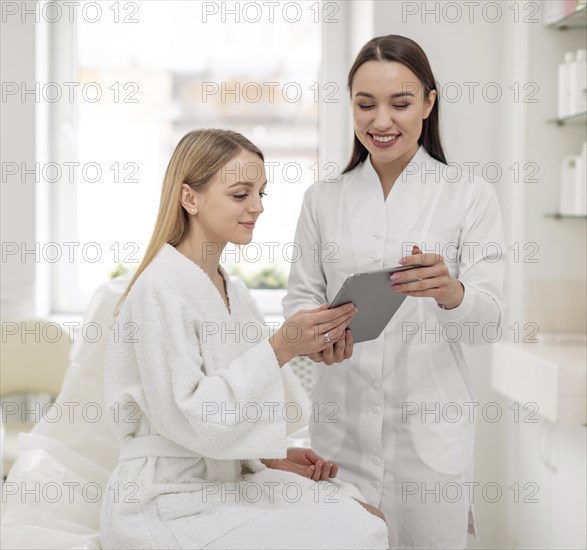 Beautician woman clinic consults client 2