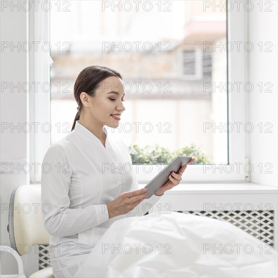 Beautician woman clinic with tablet
