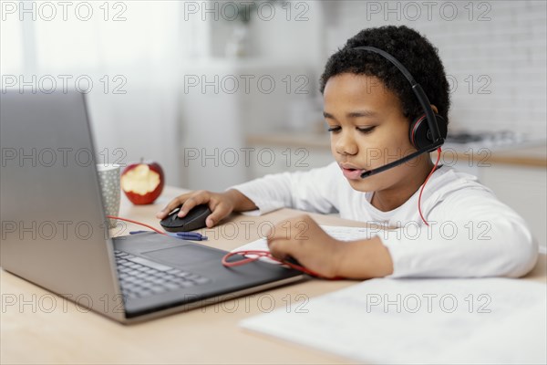 Boy doing homework with use laptop 2