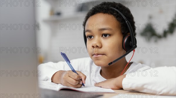 Boy doing homework with use laptop 3