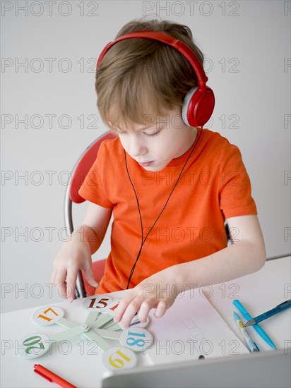 Child wearing headphones e learning concept