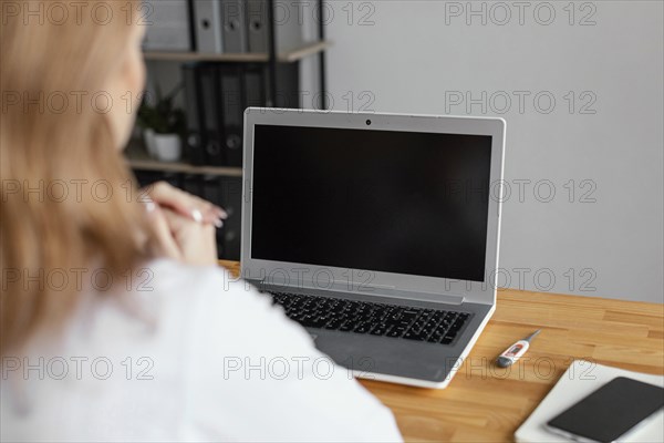 Close up doctor checking patient with laptop