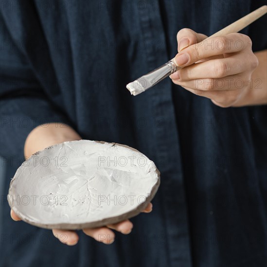 Close up hand holding plate brush