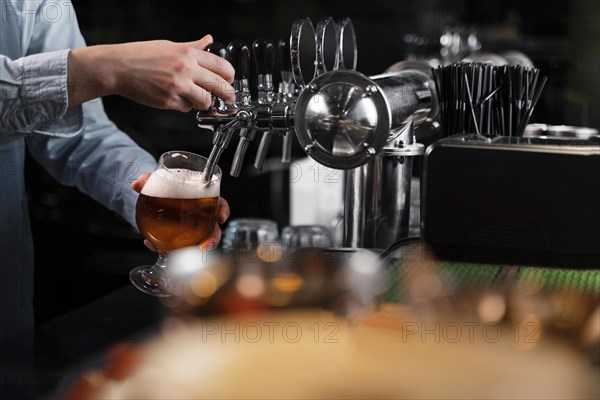 Close up hand pouring beer