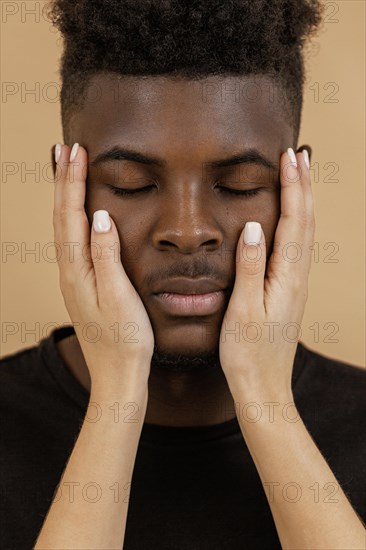 Close up hands holding man face