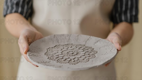 Close up hands holding plate