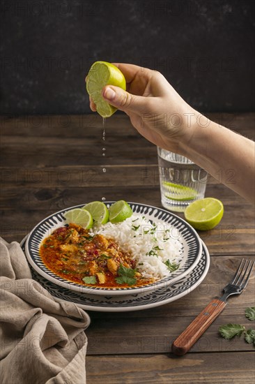 Close up hand squeezing lime juice