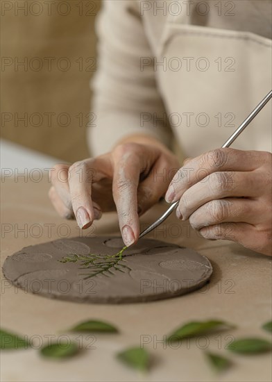 Close up hands working with plant