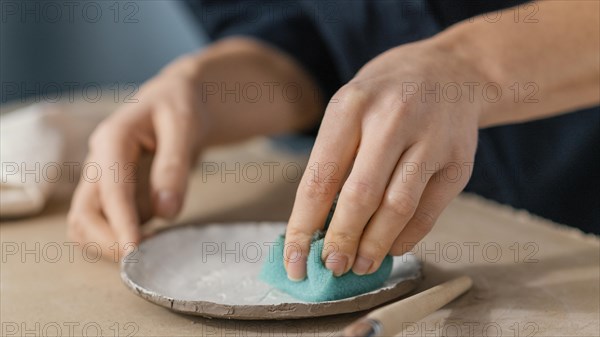 Close up hand using sponge