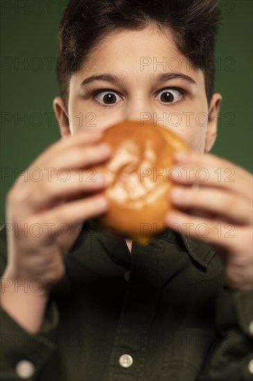 Close up kid holding donut