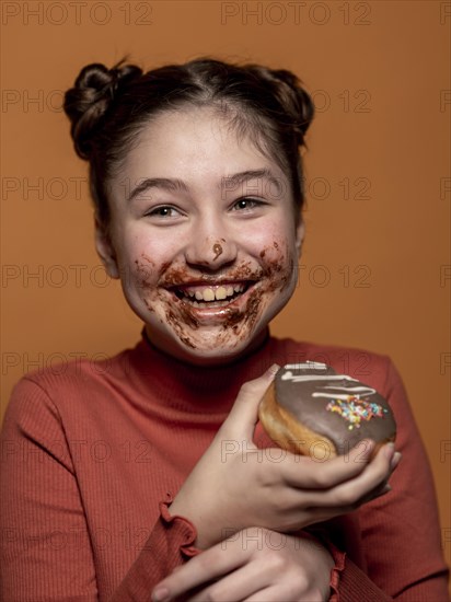 Close up kid holding doughnut