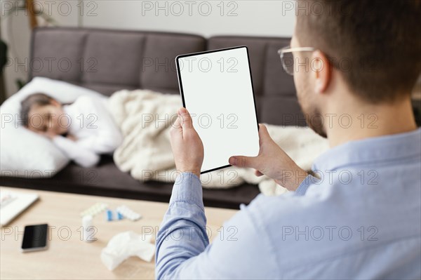 Close up man holding tablet