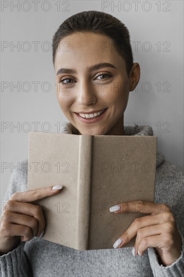 Close up smiley woman holding notebook