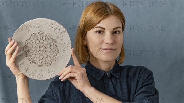 Close up smiley woman holding plate