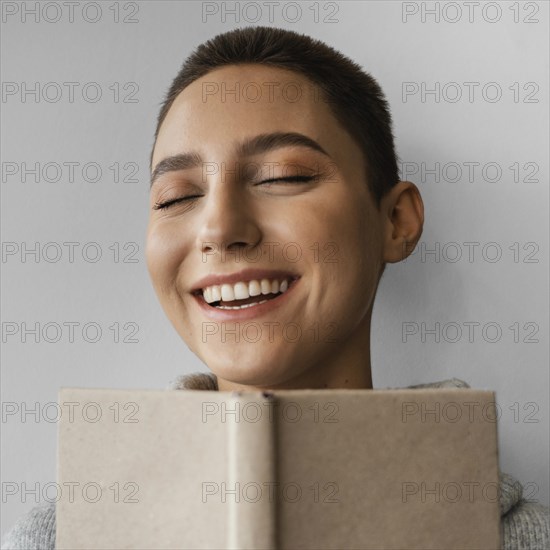 Close up smiley woman with notebook