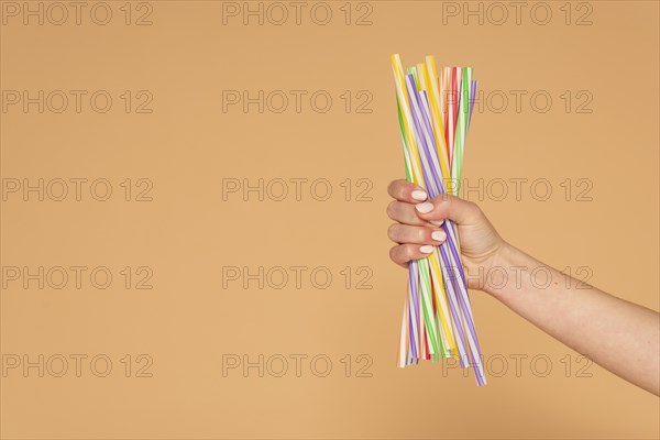 Close up woman hand with plastic straws