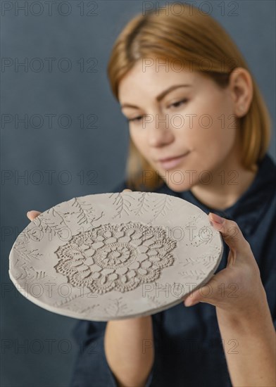 Close up woman holding decorated plate
