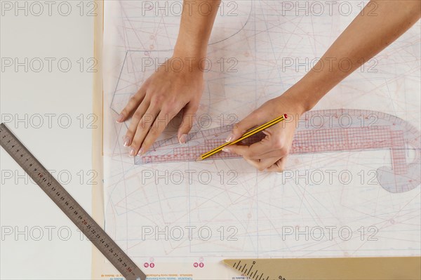 Close up woman measuring with ruler