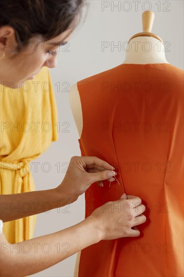 Close up woman using safety pin