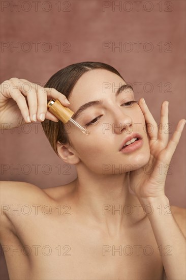 Close up woman using serum