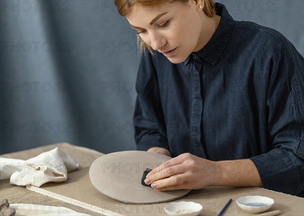 Close up woman wiping plate