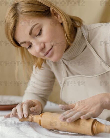 Close up woman with rolling pin