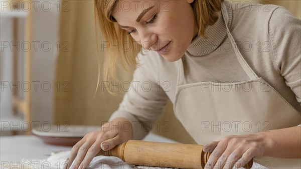 Close up woman working with rolling pin 2