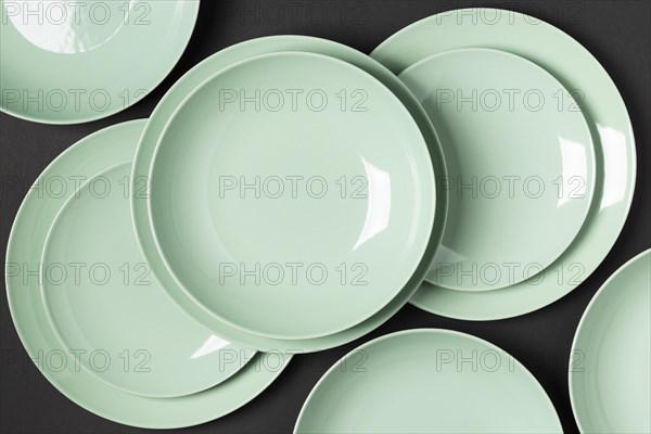 Composition different sized plates black background
