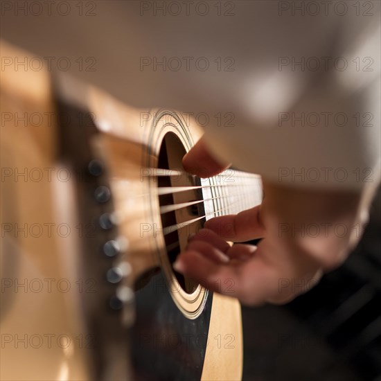 Extreme close up man person playing guitar