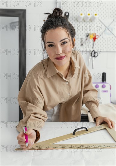 Fashion designer working her workshop alone 5