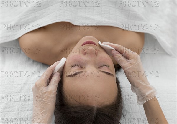 Female client salon face care routine with cleansing disks 3